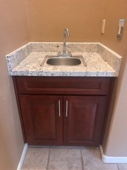 Cabinet includes bar sink & faucet