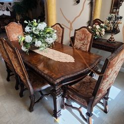 Dinning table, wall mirror, console table, canvas painting, and chandelier. 