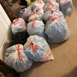 A Bundle Of 14 Large Bags Full Of Men And Women Clothes With Many Sizes + Box Of Halloween Clothes & Decorations. 
