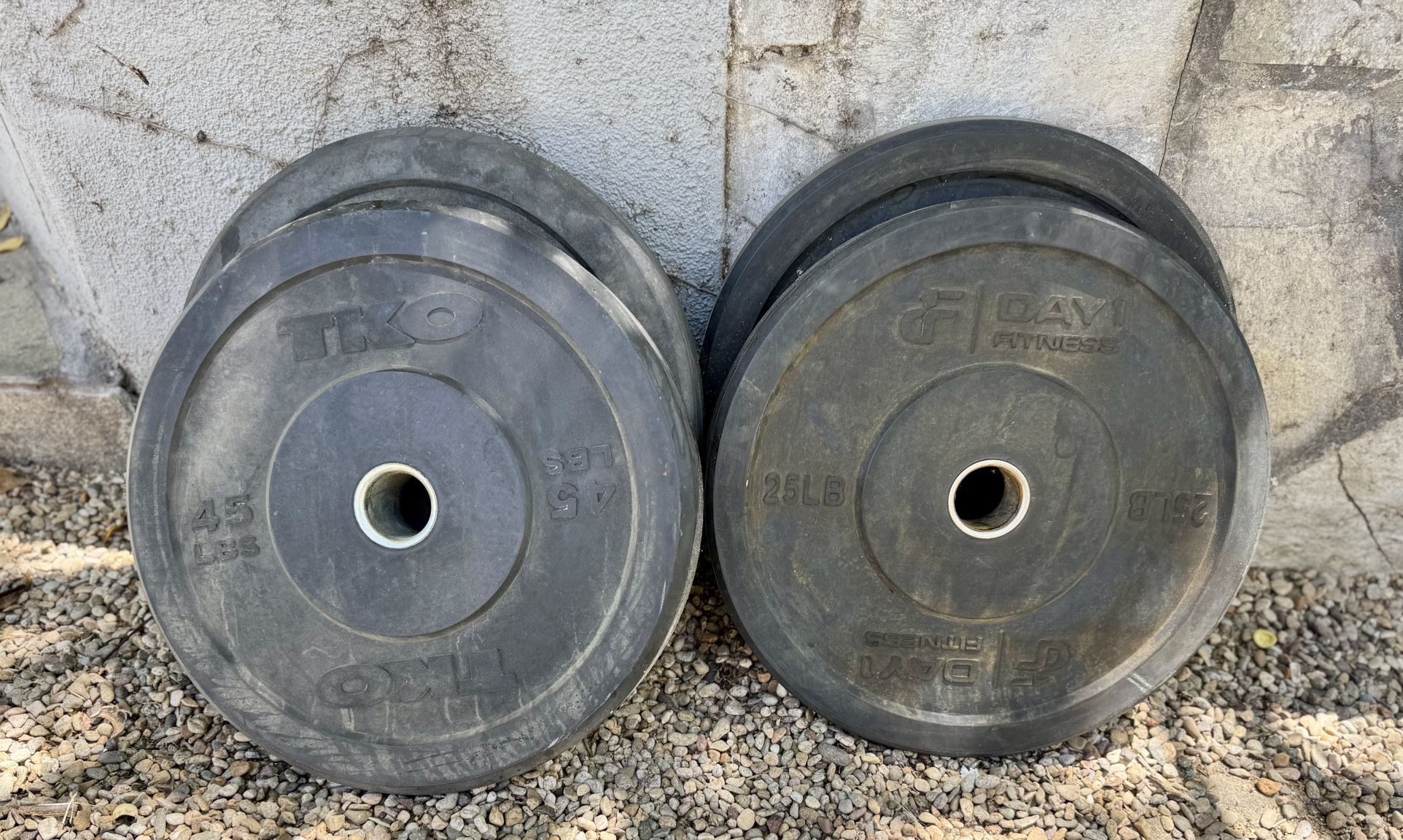 Two 45 lb And Two 25 lb Weight Plates.