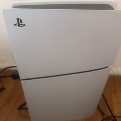 PlayStation 5 with one controller and cables