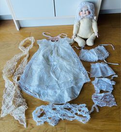 Porcelain doll to finish. Porcelain head and hands.Accessories:lace wedding dress(24” tall), trim too. Doll is 13” tallX10” wideX5” deep.