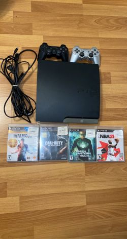 PlayStation 3 PS3 with controllers, games, and cords