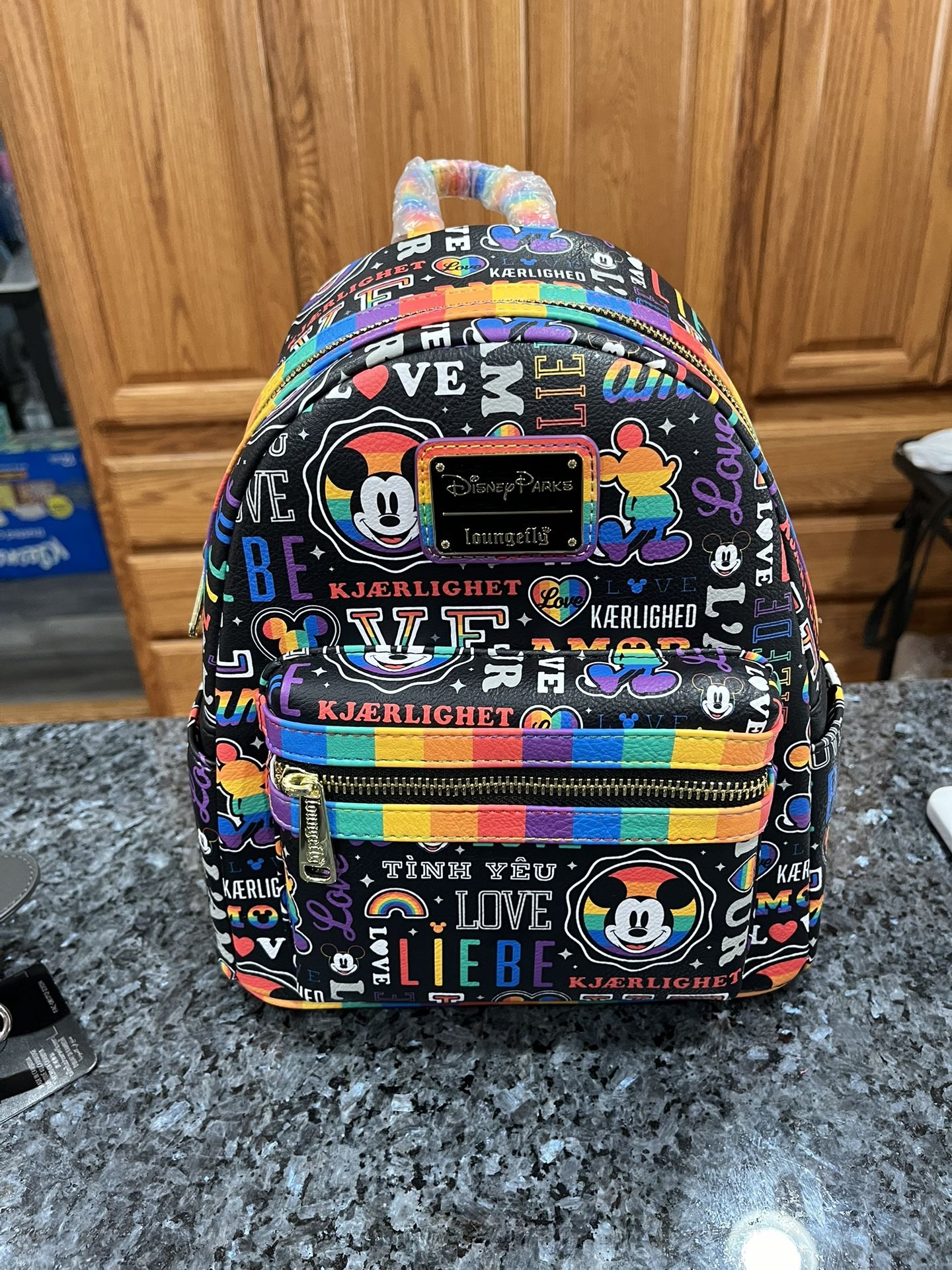 Disney Loungefly Loungefly Mickey Pride Mini Backpack. The backpack is 10 inches tall and 9 inches wide. Brand new with tags .