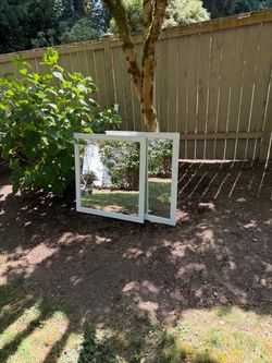 Two heavy framed vanity mirrors