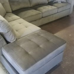 Chocolate reversible sectional with a matching ottoman