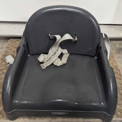 Indoor Booster Seat For A Toddler Attaches To A Chair