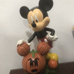 Mickey Mouse Holding a Mickey Shaped Jack O Lantern 