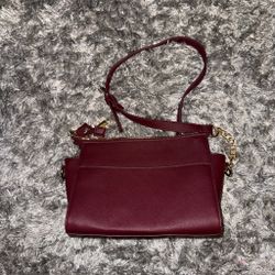 burgundy Steve Madden Blexi top-zip crossbody bag featuring gold-tone hardware.