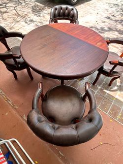 Rustic 4 foot diameter, dining table with leather wood chairs very well-made in good condition minor scuffs mainly to the legs on the chairs. Leather 