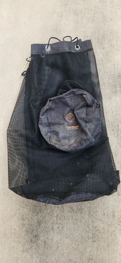 Assorted men scuba equipment: wetsuit, gloves, fans, boots, regs, bag