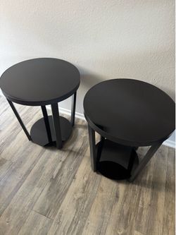Set of 2 modern tempered glass end tables/nightstands with black metal frames.