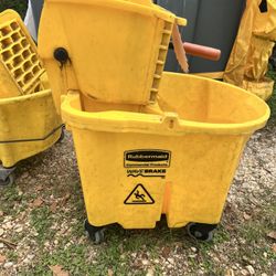 Yellow Rubbermaid WaveBrake commercial mop bucket with wringer.
