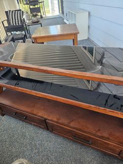 Glass TV console with shelves and drawers.