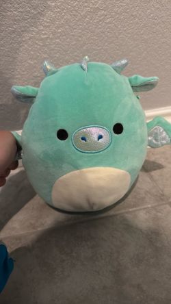 A dino squishmallow