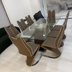 Large glass dining room table with 8 chairs