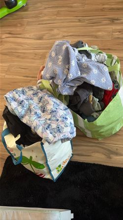 Two bags full of kids clothes different sizes