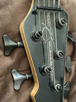 Peavey Millennium BXP 4-string electric bass guitar.The headstock features a black finish with signature Millennium series styling and black