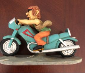 Vintage  comical resin figurine featuring a stylized biker riding a teal motorcycle,  Size 8 inches x 5-1/2 inches $15