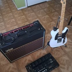 Vox Amplifier With Guitar And Pedal