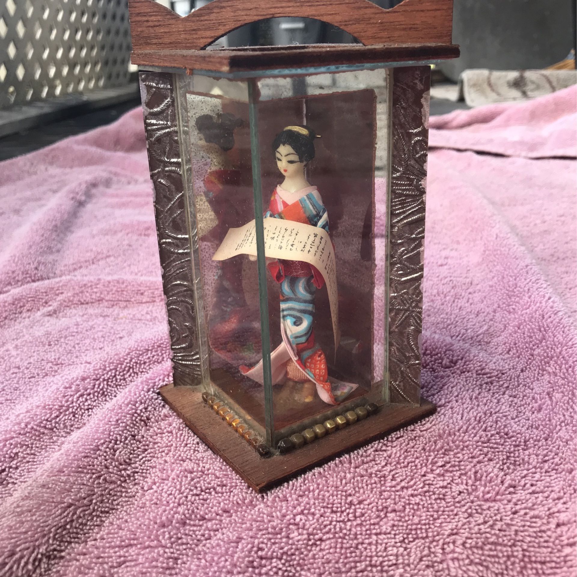 Japanese doll in glass case