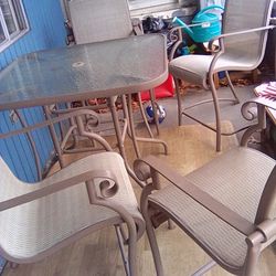 Glass Patio Umbrella Table With Four High Back Chairs That Match