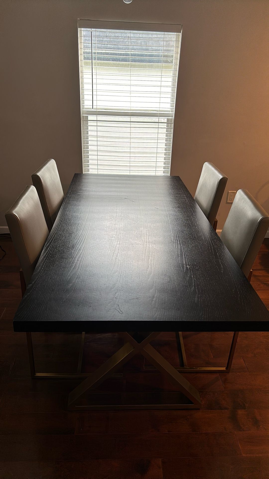 Black Wooden Table With Grey Chairs And Brass Legs
