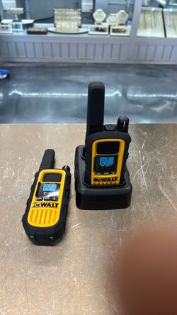 Used Dewalt Waterproof Walkie Talkie Pair on Charging Dock