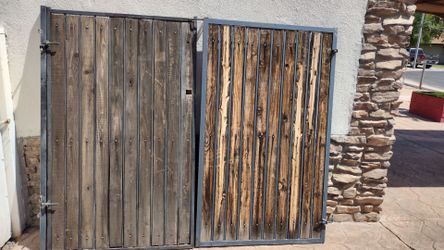 Black metal door gate. .wood panel.  Size.  8'feet wide X. 6'feet tall.     $.   250.