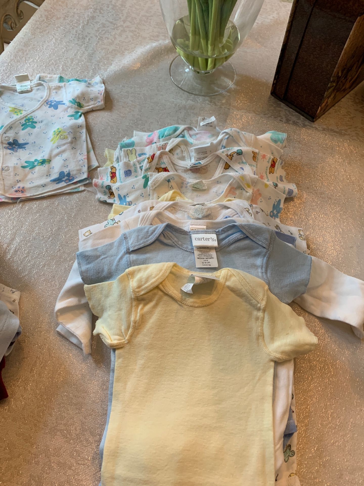 Lot of about 15 onesies 0-3 months and up to 13 lbs and a few shirts