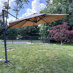 Outdoor Cantilever Umbrella Patio Umbrella with Base. Multiple levels and angles to direct shade.