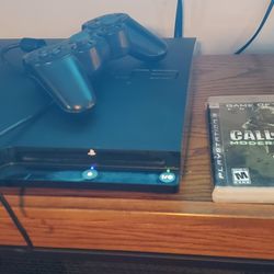 PS3 Slim Console, 2 wireless controllers, and games