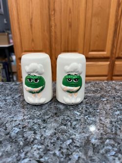 M & M’s White with Green pair of salt and pepper shakers.  Preowned.  Has been on display in a cabinet with a very large salt and pepper shakers colle