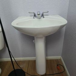 Pedestal sink with faucet