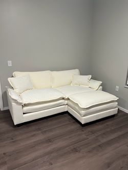 Cream Sectional Sofa with an Ottoman