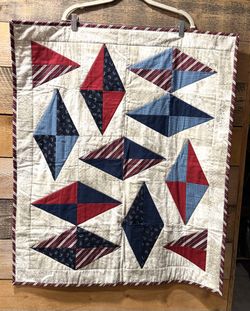 Handmade Baby / Lap Quilt Americana 28” x 34”   The quilt is constructed using half-square triangle units arranged to form a series of large diamond s