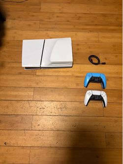 door, shock controllers white Sony PlayStation 5 Slim Disc Edition with white and blue controllers