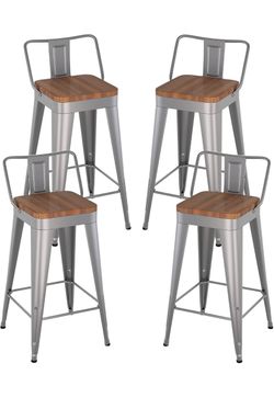 Four 30” silver metal barstools wit low backs and wood seats.