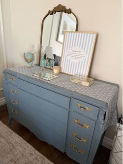 Blue dresser with gold handles
