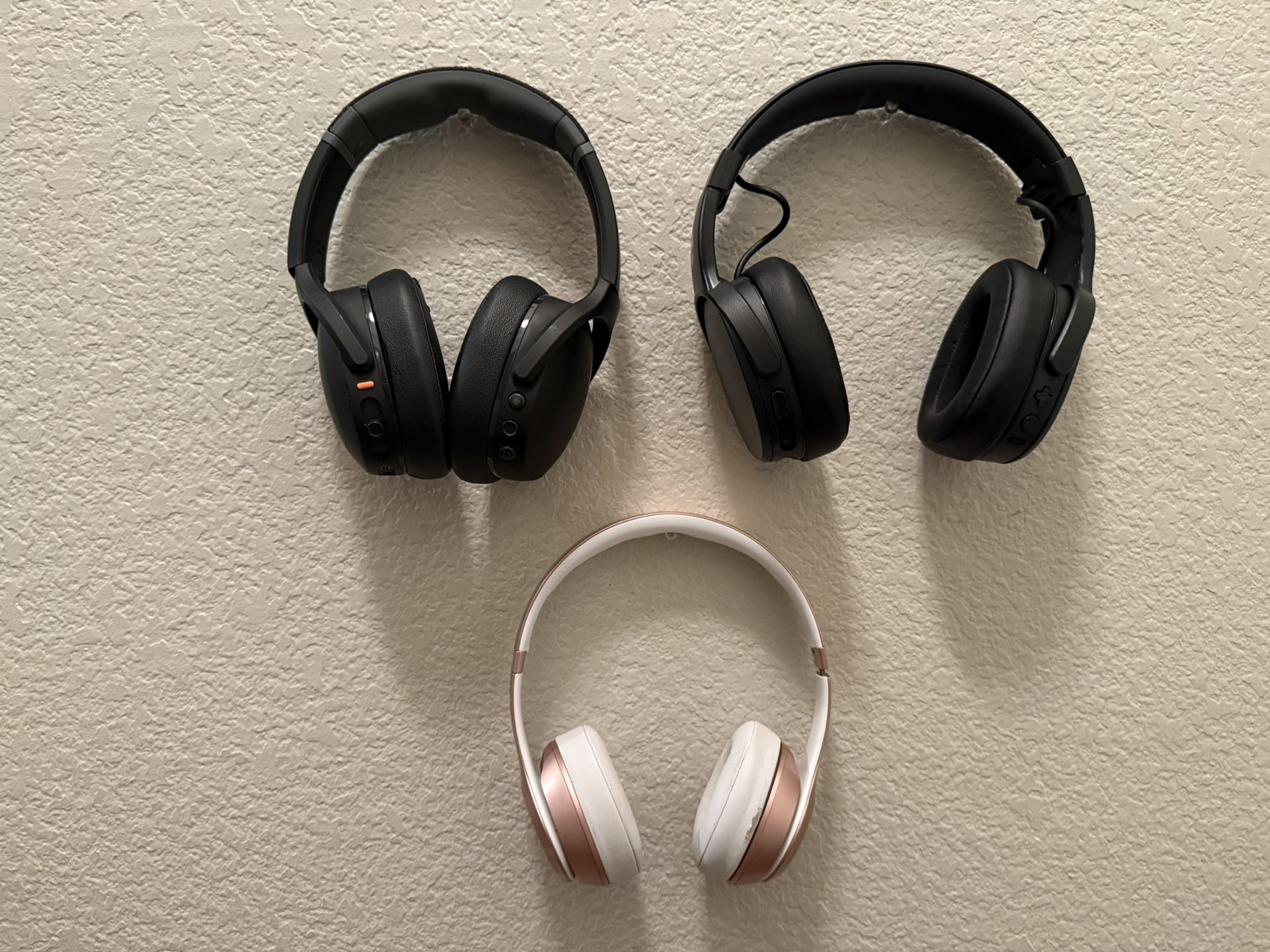 Three Overhead Earphones. 2 Skull Candy Crusher Evo & One BeatsSolo Wireless
