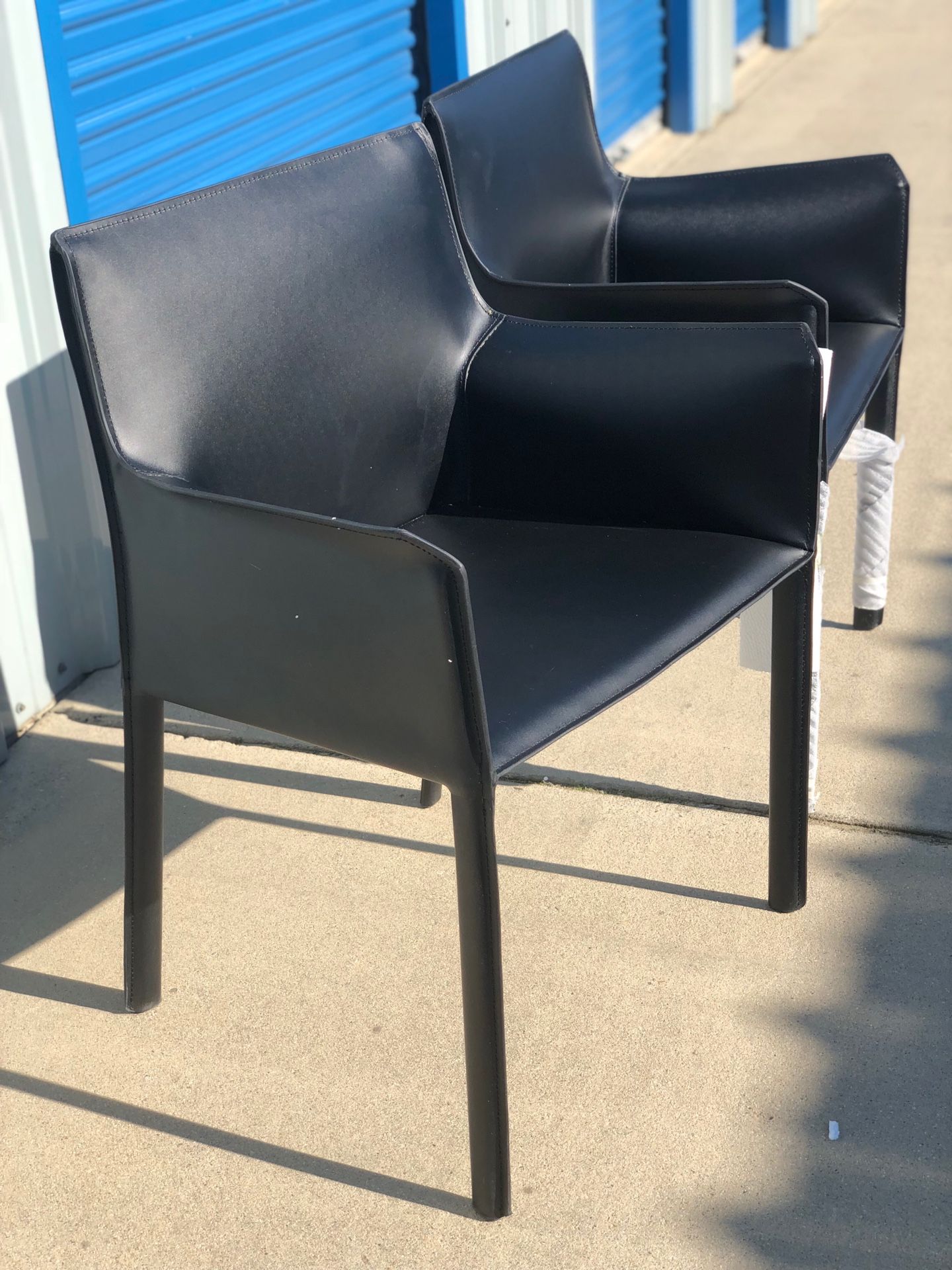Brand new set of 2 black leather arm chairs. Retails for over $450