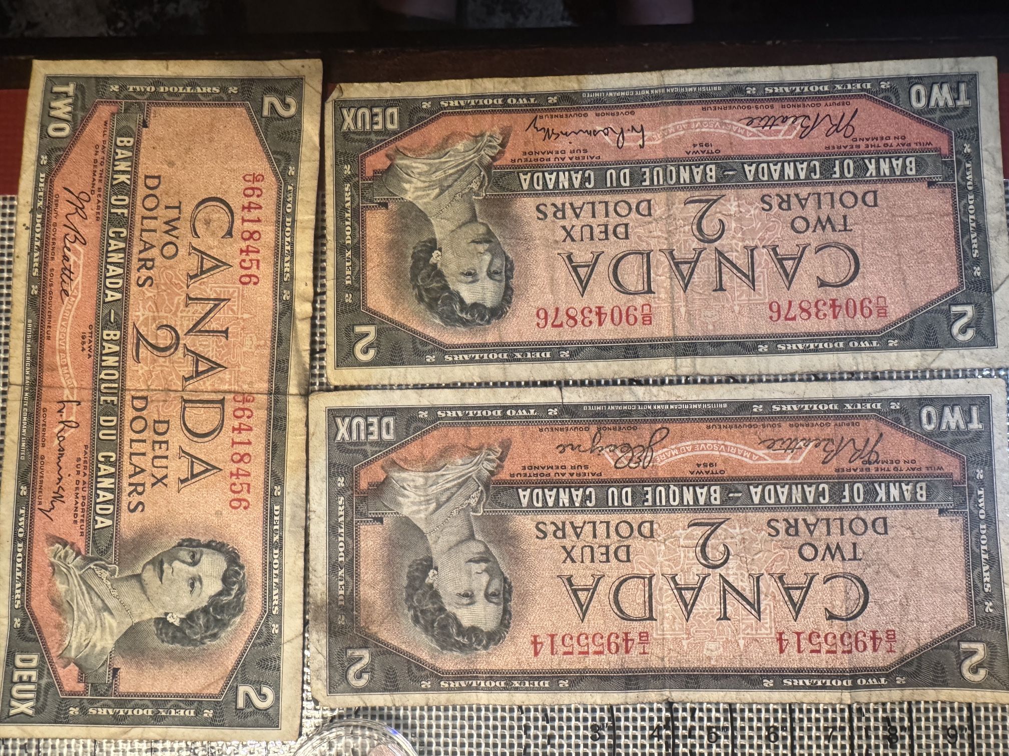 These are 1954 Canadian two-dollar bills. DevilsHead