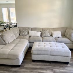 Large beige sectional couch + ottoman
