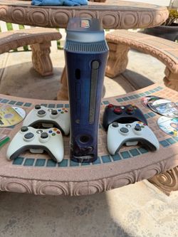XBOX 360 game console with four controllers and a bunch of games