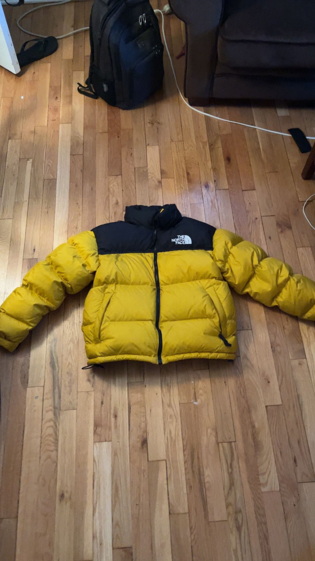 yellow & black north face puffer
