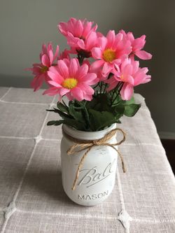 Distressed mason jar with silk flowers