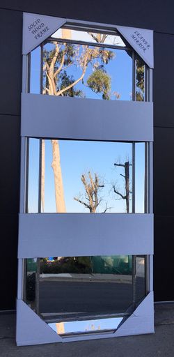 Large framed mirror. All pieces are beveled. New in box. Slight imperfection on the bottom of the mirror. 30x72.