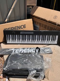 TERENCE 61-key portable electronic keyboard. The keyboard, carrying case, music stand, and original box are all present