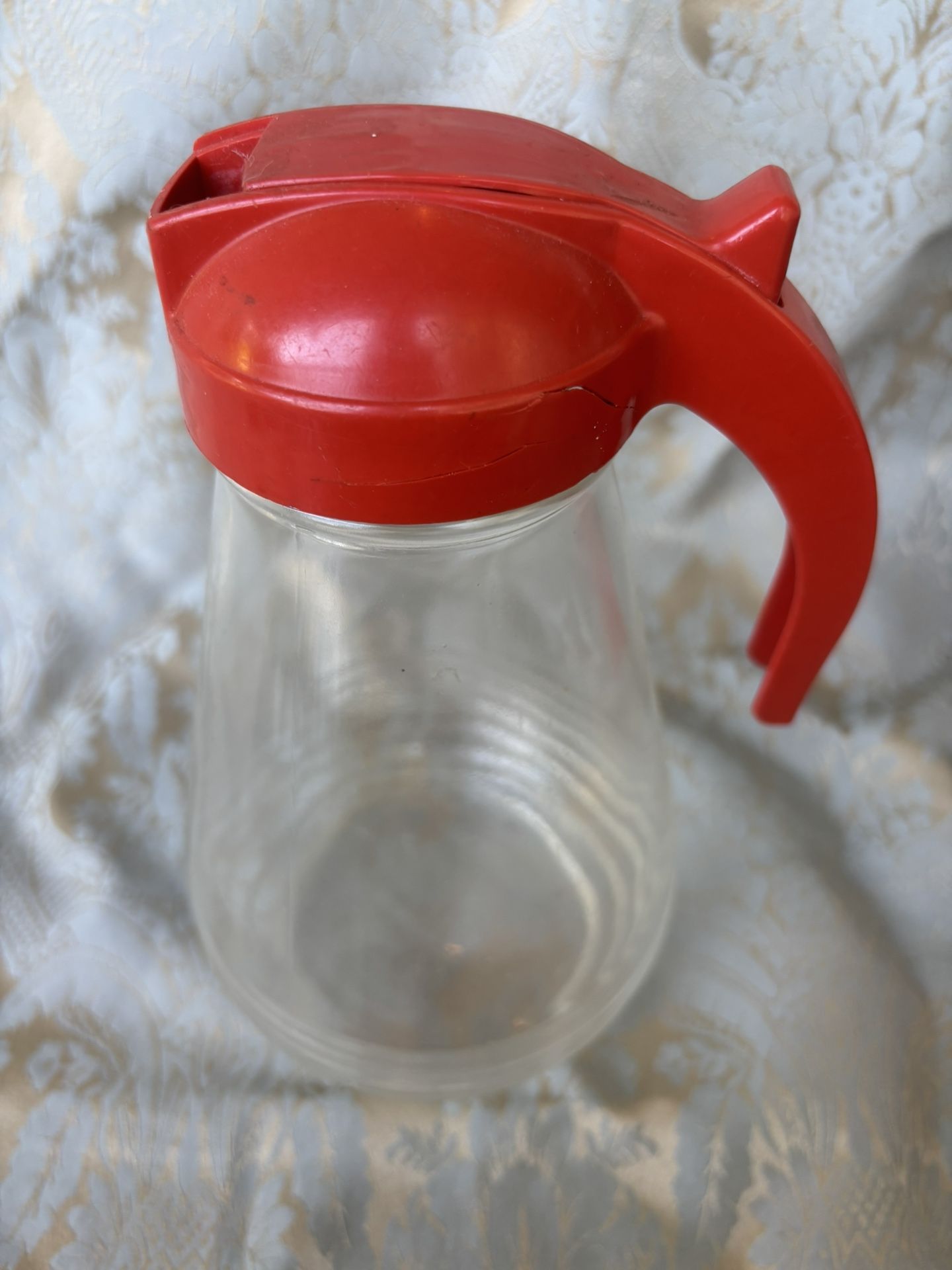 Vintage Large Hazel Atlas glass batter or syrup pitcher with red plastic lid, likely 1950s. Crack on lid.