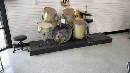 Stagg acoustic drum set in a metallic champagne gold or silver-gold sparkle finish.